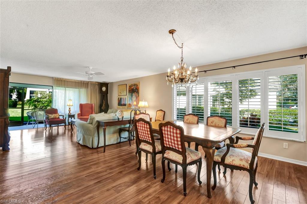 1617 Spoonbill Lane, Unit 1617 Naples, FL 34105 - Photo 9 of 31 a view of a dining room with furniture window and wooden floor