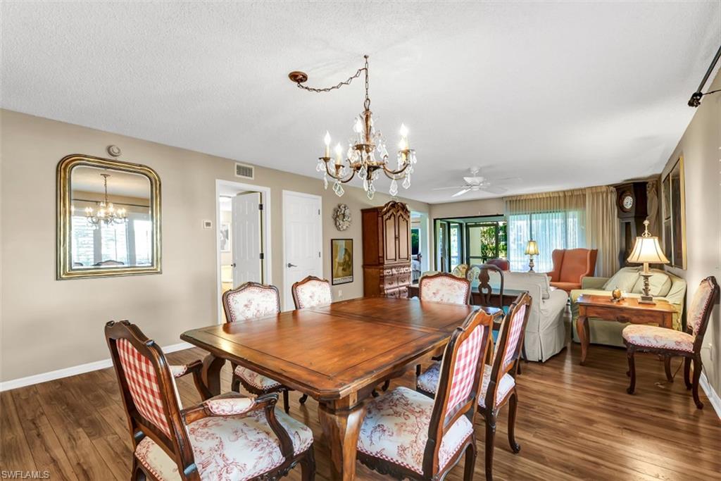 1617 Spoonbill Lane, Unit 1617 Naples, FL 34105 - Photo 10 of 31 a view of a dining room with furniture window and wooden floor