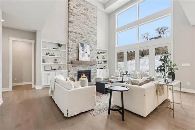 a living room with furniture a fireplace and a painting