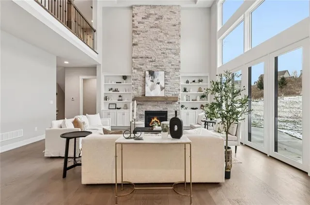 a living room with furniture a fireplace and a potted plant
