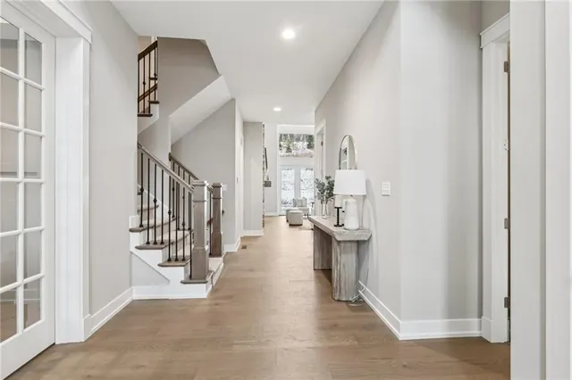 a view of entryway and hall with wooden floor