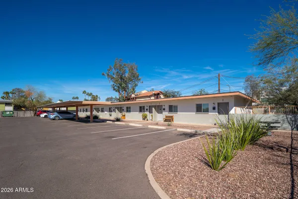 a front view of a house with a yard and outdoor seating