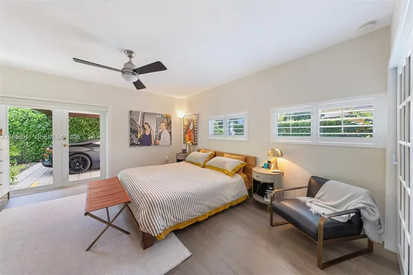 a bedroom with a bed couch and window