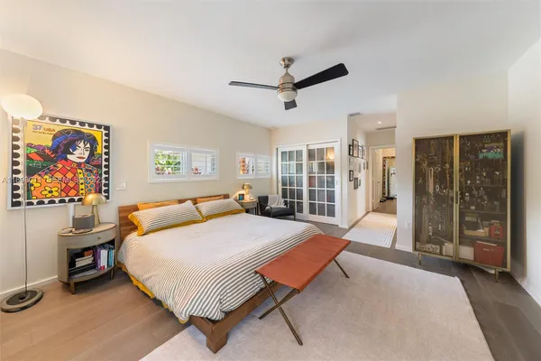 a bedroom with a bed and a large window