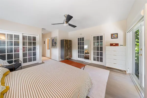 a bedroom with a bed closet and window