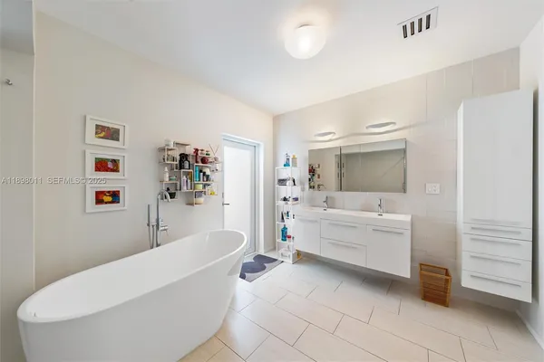 a bathroom with a bathtub and sink