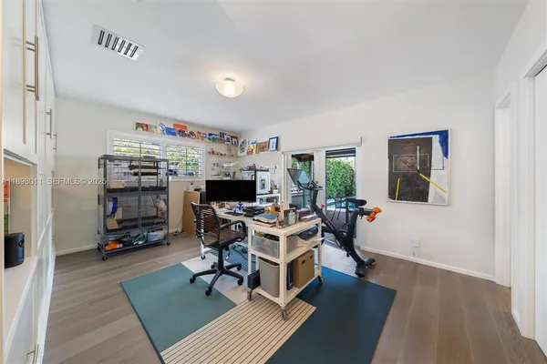 a view of a workspace with furniture and a rug