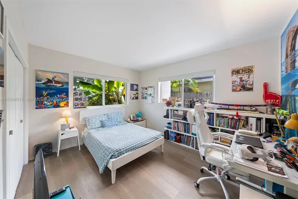 a bedroom with a bed and a bookshelf