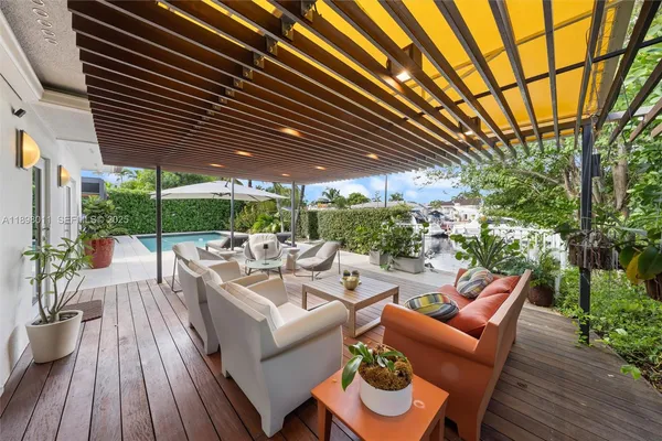 a view of a patio with couches table and chairs and potted plants