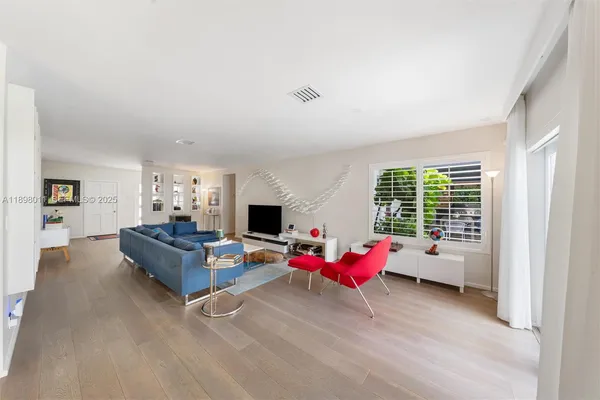 a living room with furniture and flat screen tv