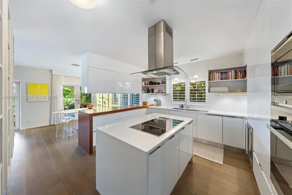 a kitchen that has a lot of cabinets a sink and a stove in it