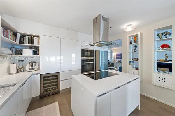 a kitchen with stainless steel appliances granite countertop a sink and a stove