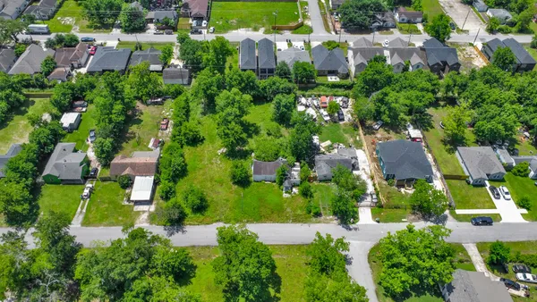 an aerial view of a house with a yard and garden