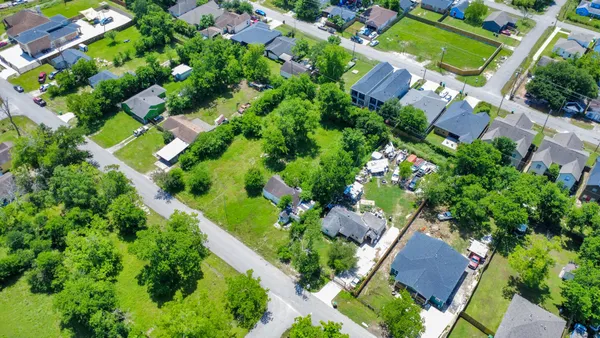 an aerial view of lots of trees and houses
