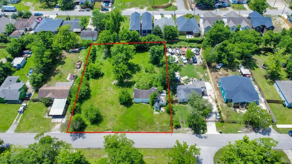 an aerial view of house with yard and swimming pool
