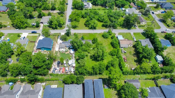 an aerial view of residential houses with outdoor space and street view