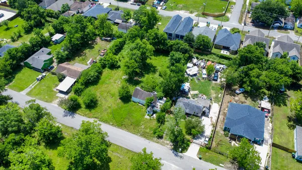 an aerial view of a house with a yard