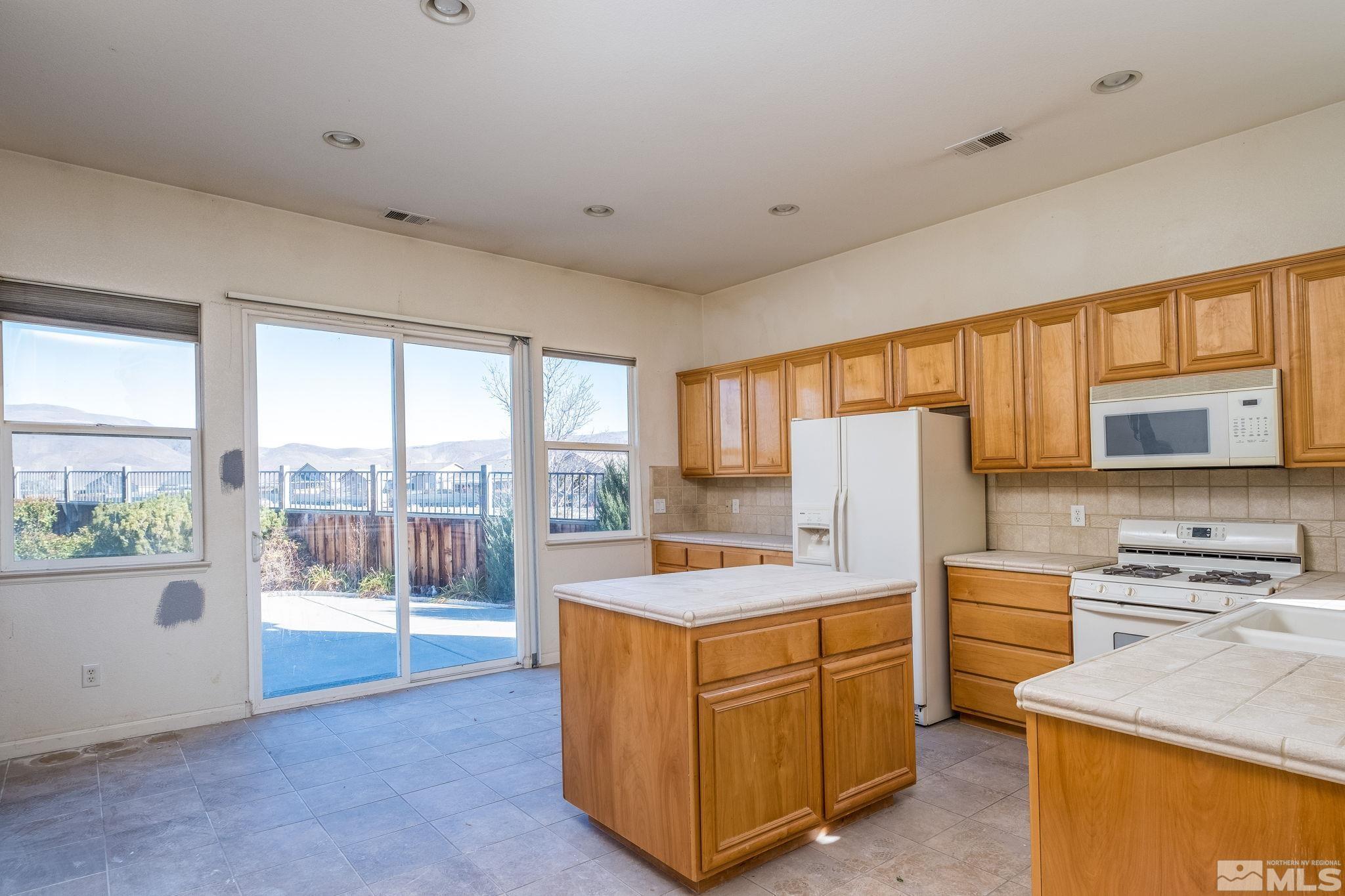 1831 Emerald Bay Drive Reno, NV 89521 - Photo 8 of 34 a kitchen with a stove a sink and a refrigerator