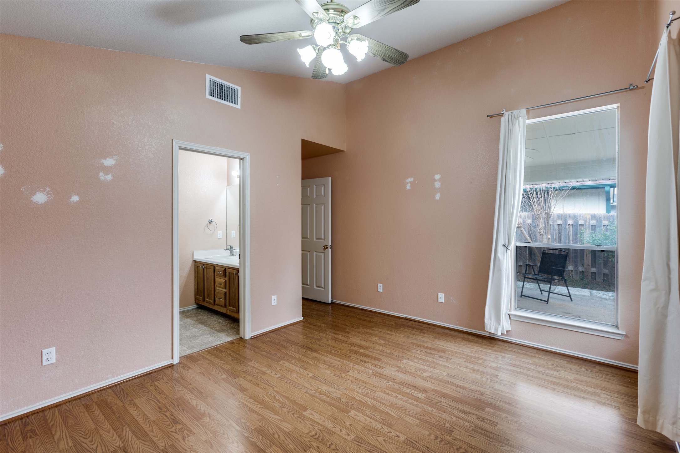 9057 Vigen Circle Austin, TX 78748 - Photo 18 of 27 wooden floor in an empty room with a window