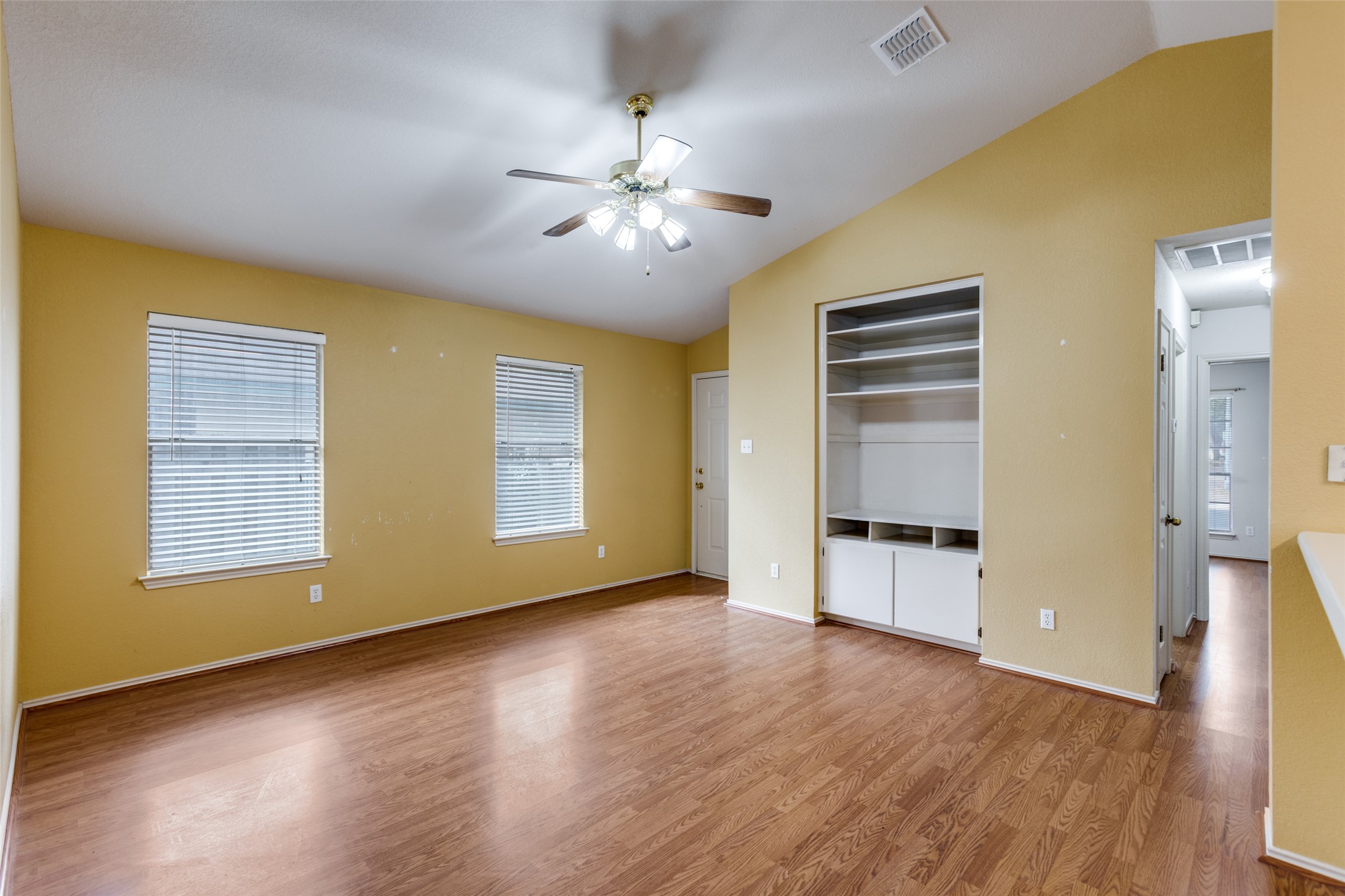 9057 Vigen Circle Austin, TX 78748 - Photo 6 of 27 a view of an empty room with a window and wooden floor