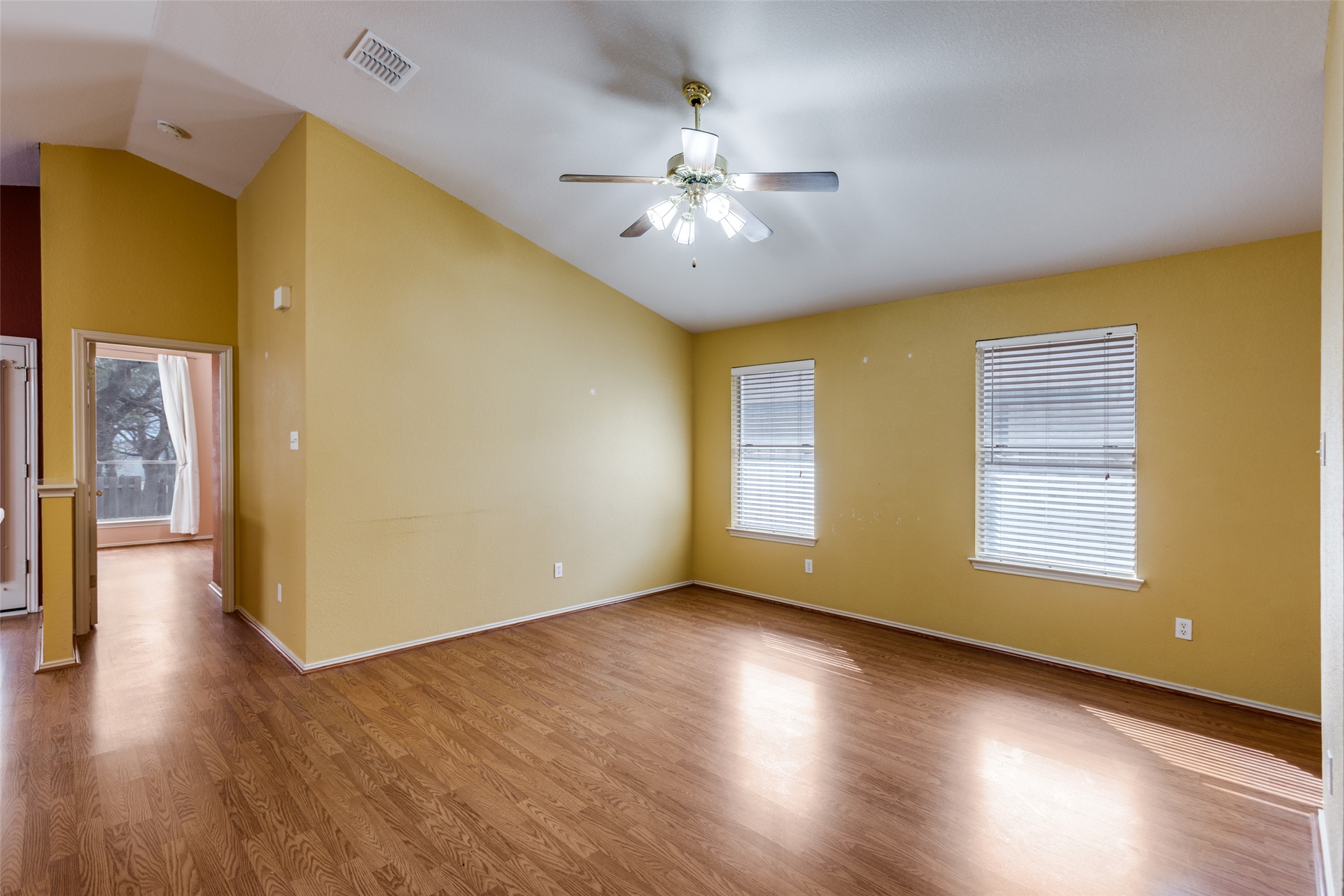 9057 Vigen Circle Austin, TX 78748 - Photo 7 of 27 a view of an empty room with wooden floor and a window