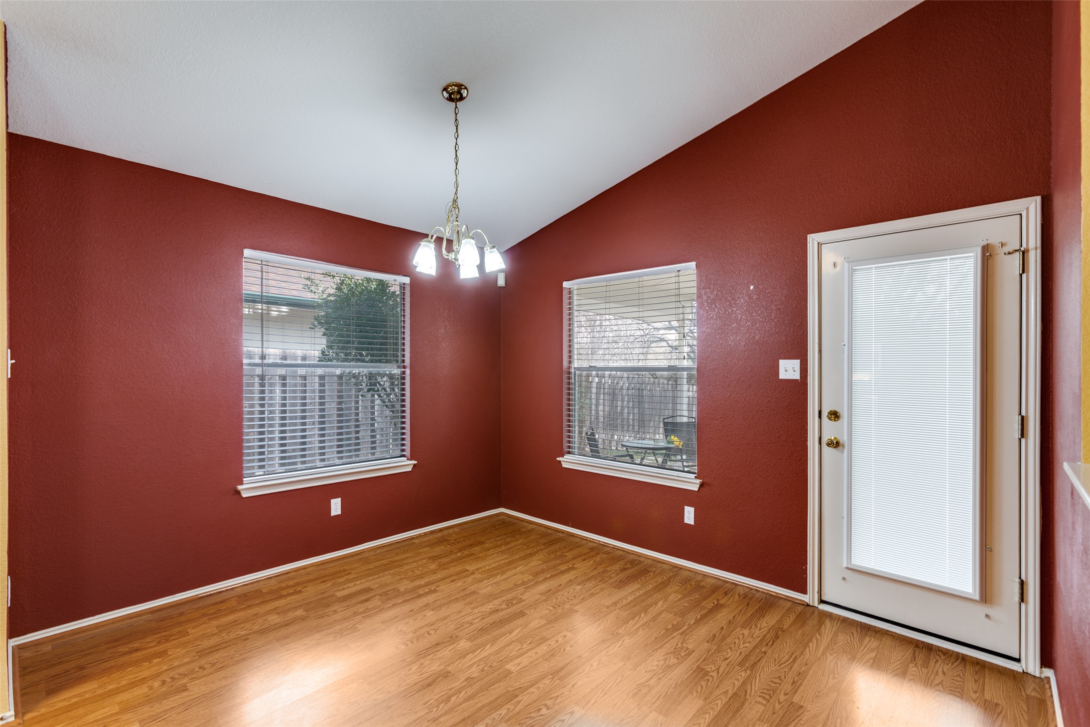9057 Vigen Circle Austin, TX 78748 - Photo 8 of 27 an empty room with chandelier fan and windows