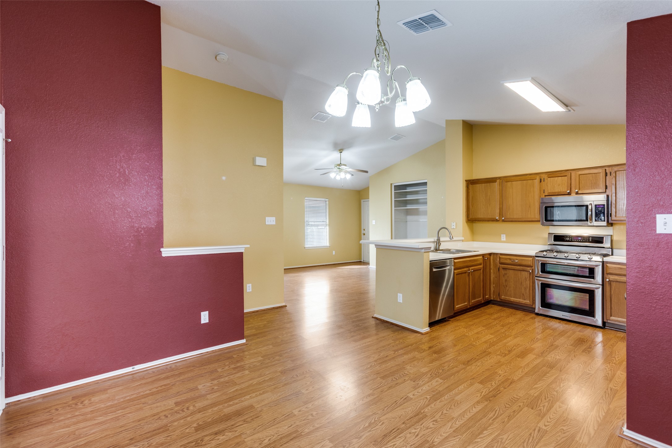 9057 Vigen Circle Austin, TX 78748 - Photo 10 of 27 a kitchen with stainless steel appliances granite countertop a sink cabinets and wooden floor