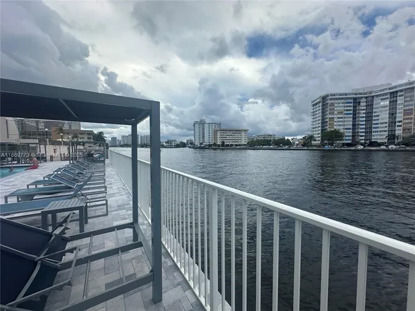 a room with pool table and windows