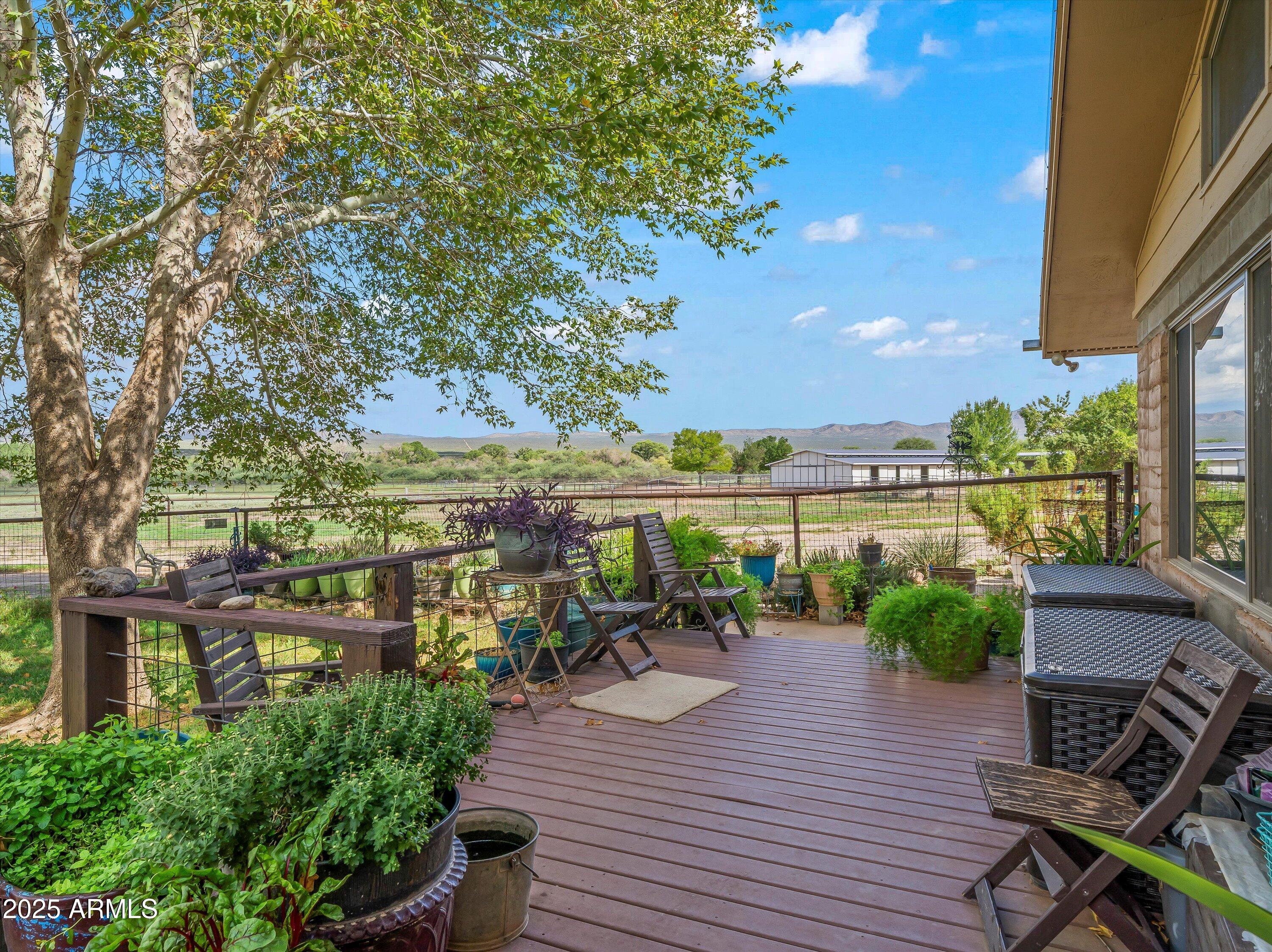 4489 North Ocotillo Road Benson, AZ 85602 - Photo 14 of 60 a view of a balcony with chairs and wooden floor