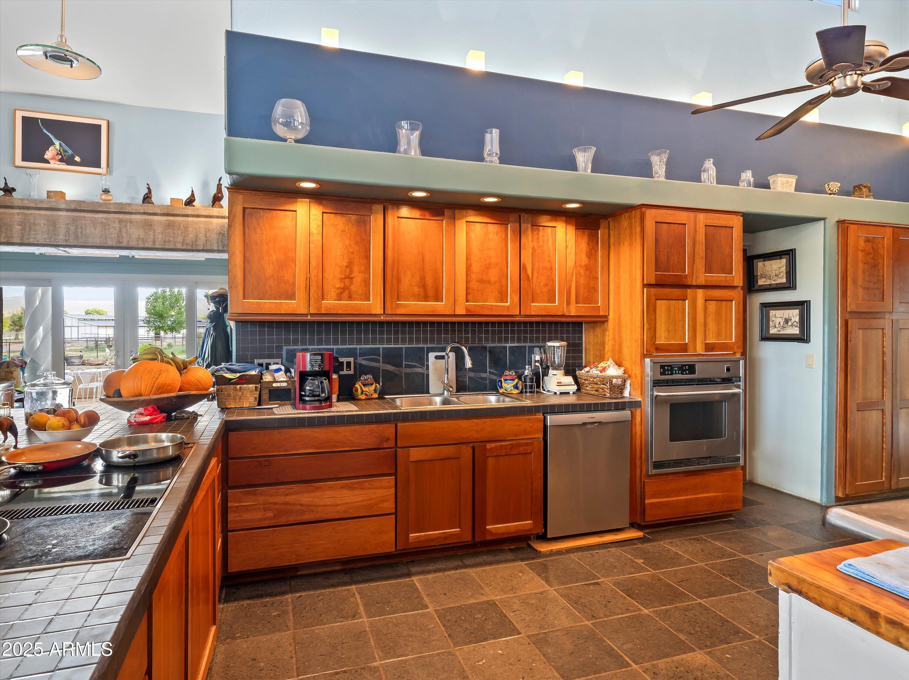 4489 North Ocotillo Road Benson, AZ 85602 - Photo 19 of 60 a kitchen with stainless steel appliances granite countertop a stove and a sink
