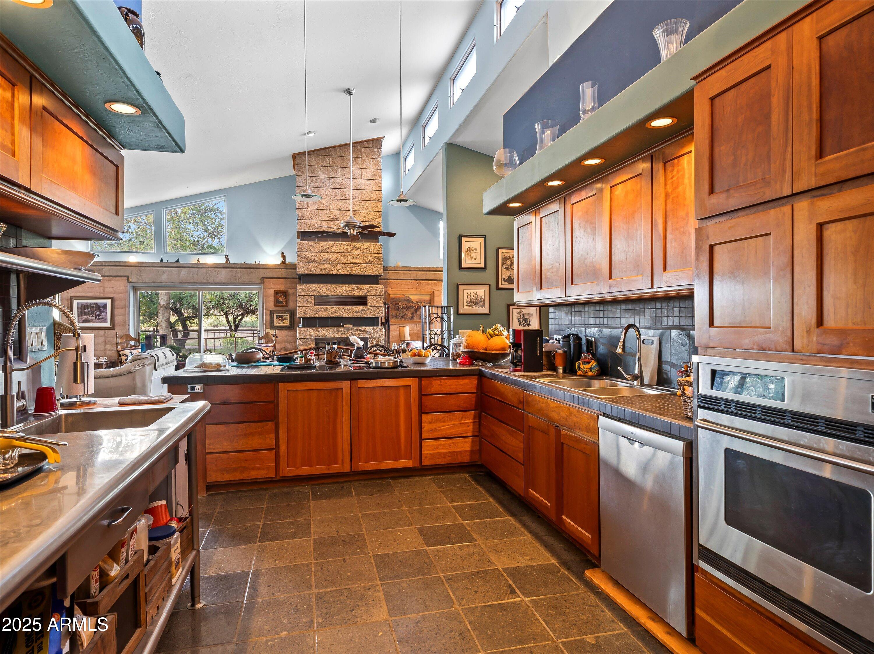 4489 North Ocotillo Road Benson, AZ 85602 - Photo 21 of 60 a kitchen with stainless steel appliances granite countertop a sink and cabinets