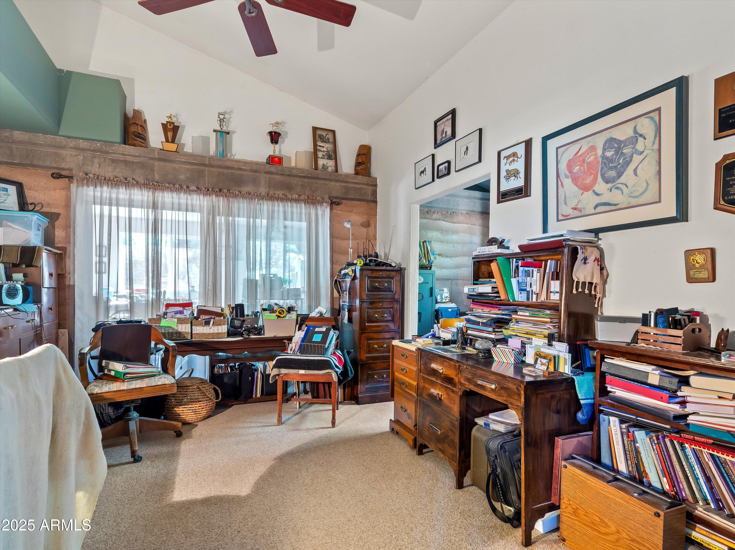 4489 North Ocotillo Road Benson, AZ 85602 - Photo 30 of 60 a living room with lots of furniture and a flat screen tv