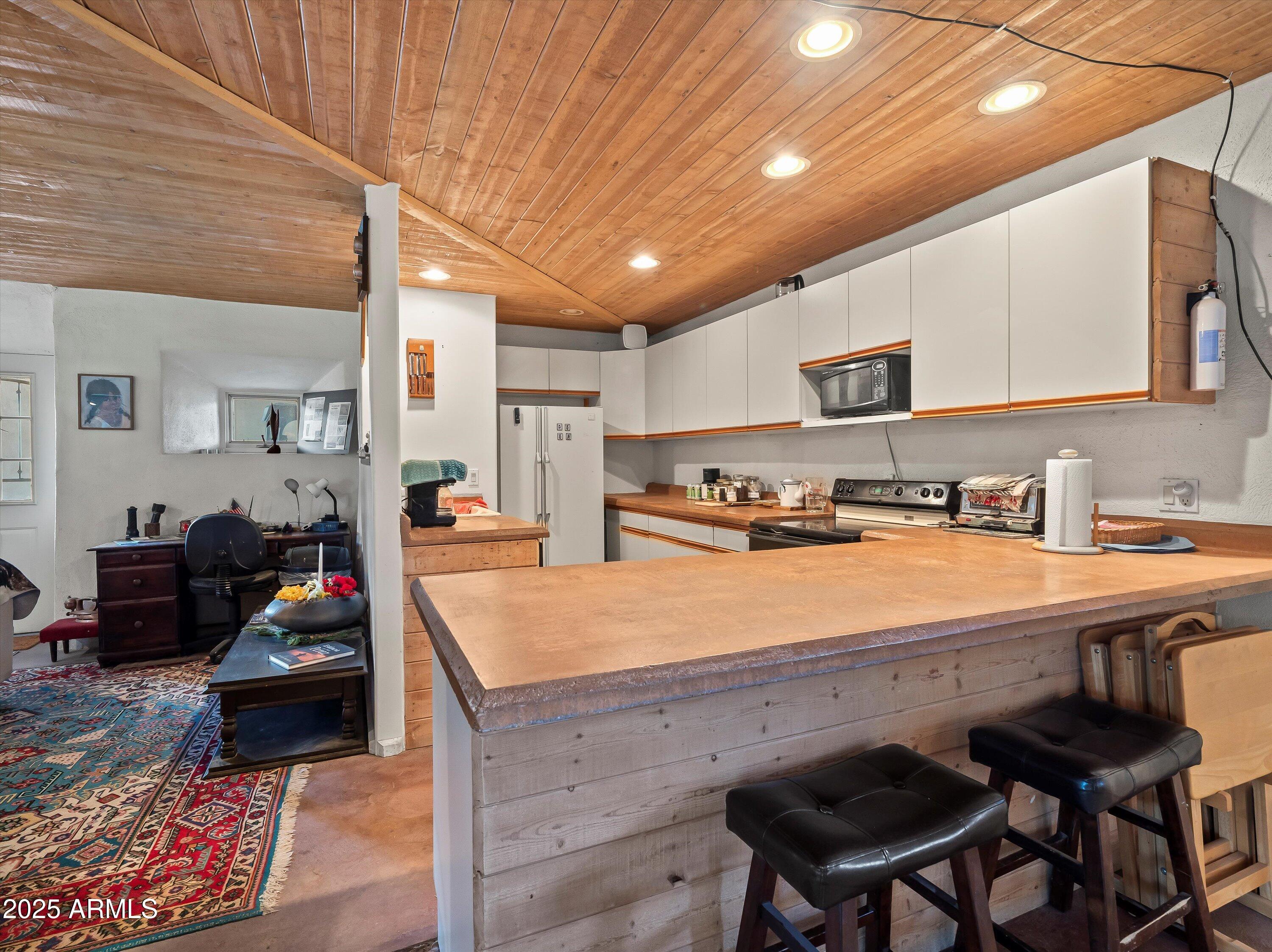 4489 North Ocotillo Road Benson, AZ 85602 - Photo 46 of 60 a living room with stainless steel appliances kitchen island granite countertop furniture and a kitchen view