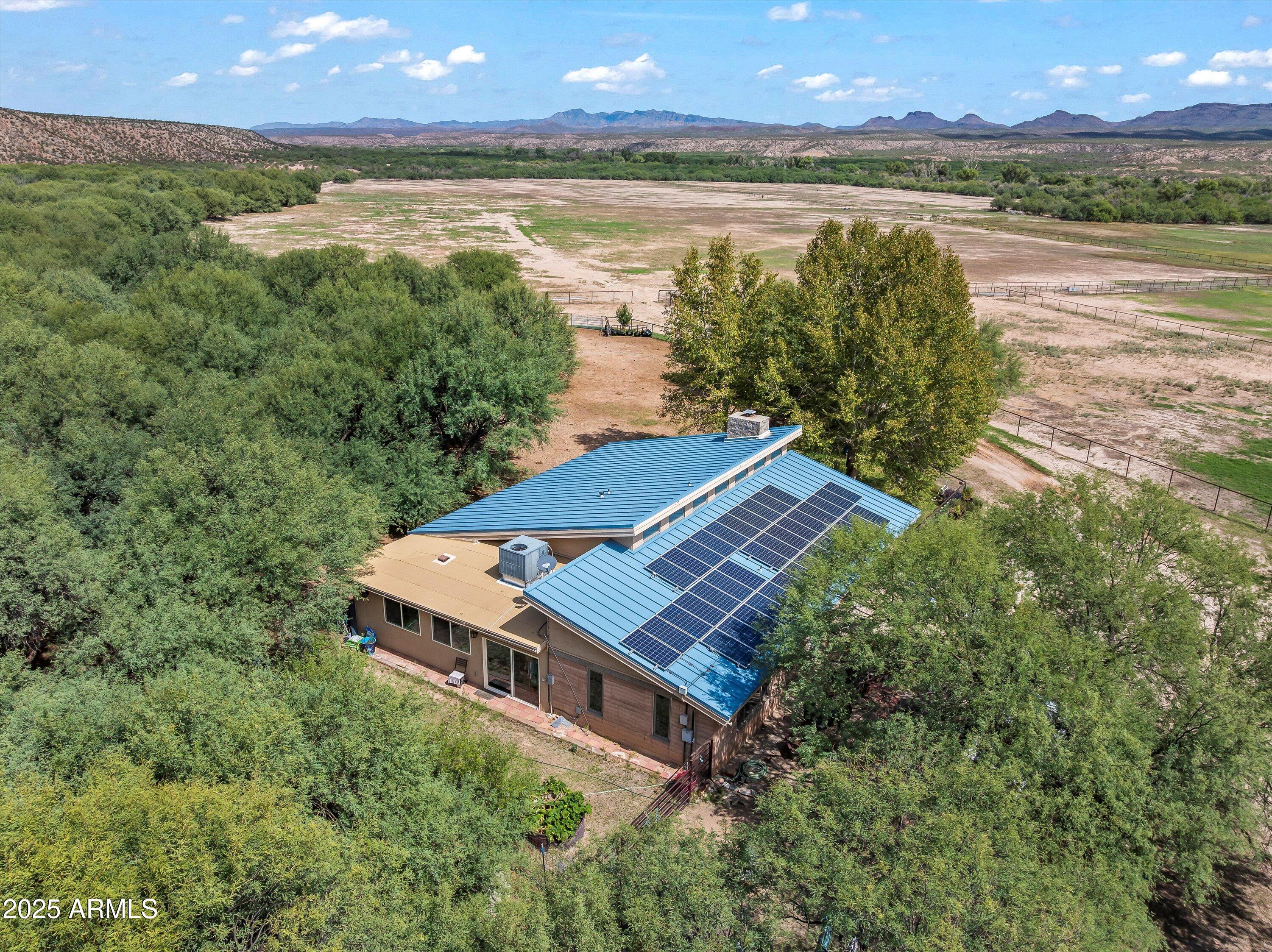 4489 North Ocotillo Road Benson, AZ 85602 - Photo 10 of 60 an aerial view of a house with a garden and lake view