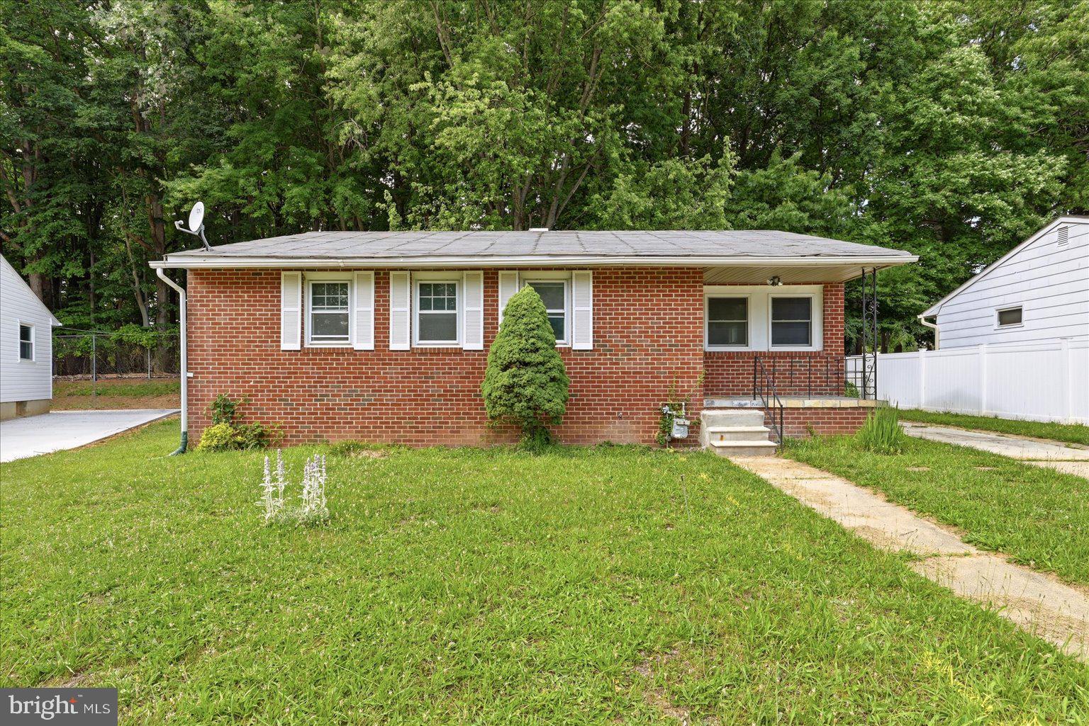 9110 Meadow Heights Road Randallstown, MD 21133 - Photo 1 of 39 Charming brick home with lush greenery.