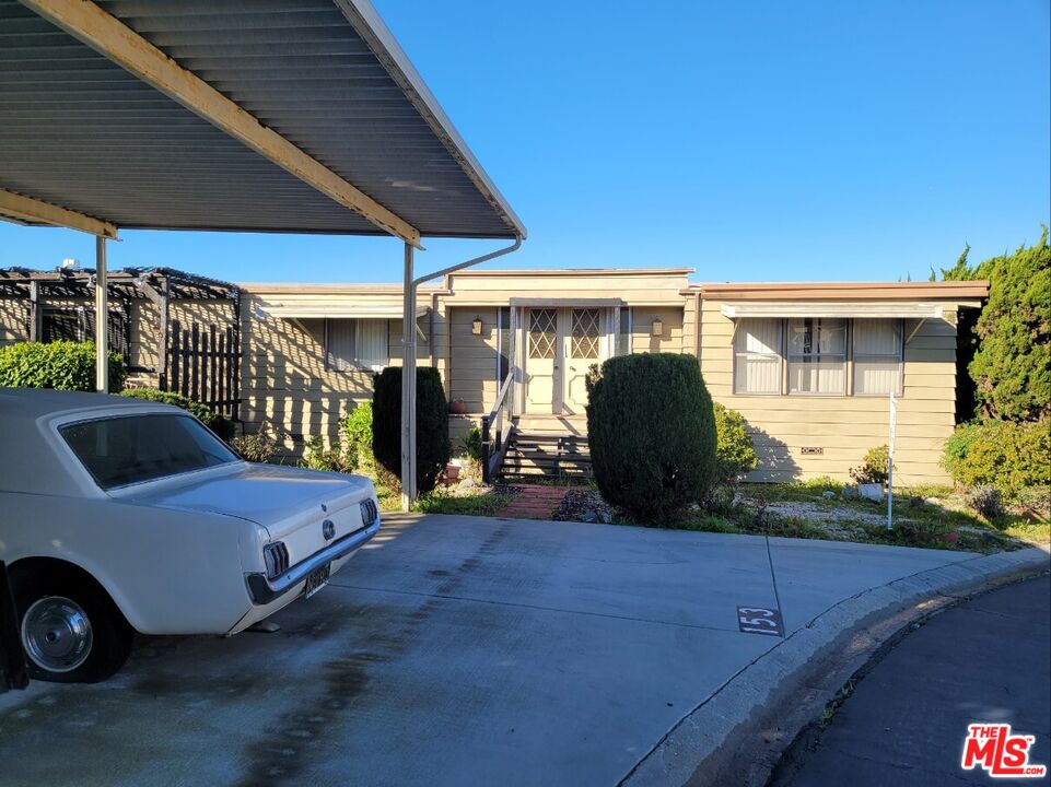 17700 South Avalon Boulevard, Unit 153 Carson, CA 90746 - Photo 2 of 17 a view of a patio with table and chairs under an umbrella