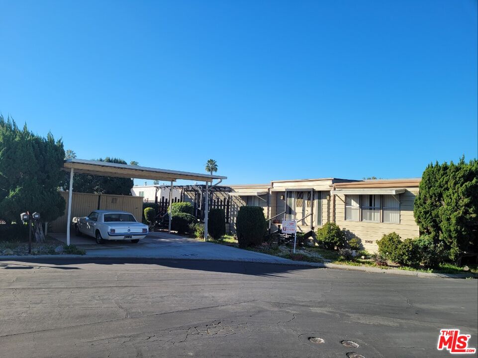 17700 South Avalon Boulevard, Unit 153 Carson, CA 90746 - Photo 3 of 17 a front view of a house with a yard and mountain view