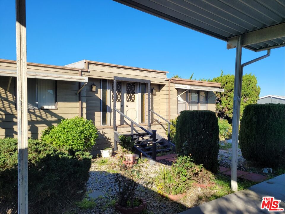 17700 South Avalon Boulevard, Unit 153 Carson, CA 90746 - Photo 5 of 17 a front view of a house with a yard