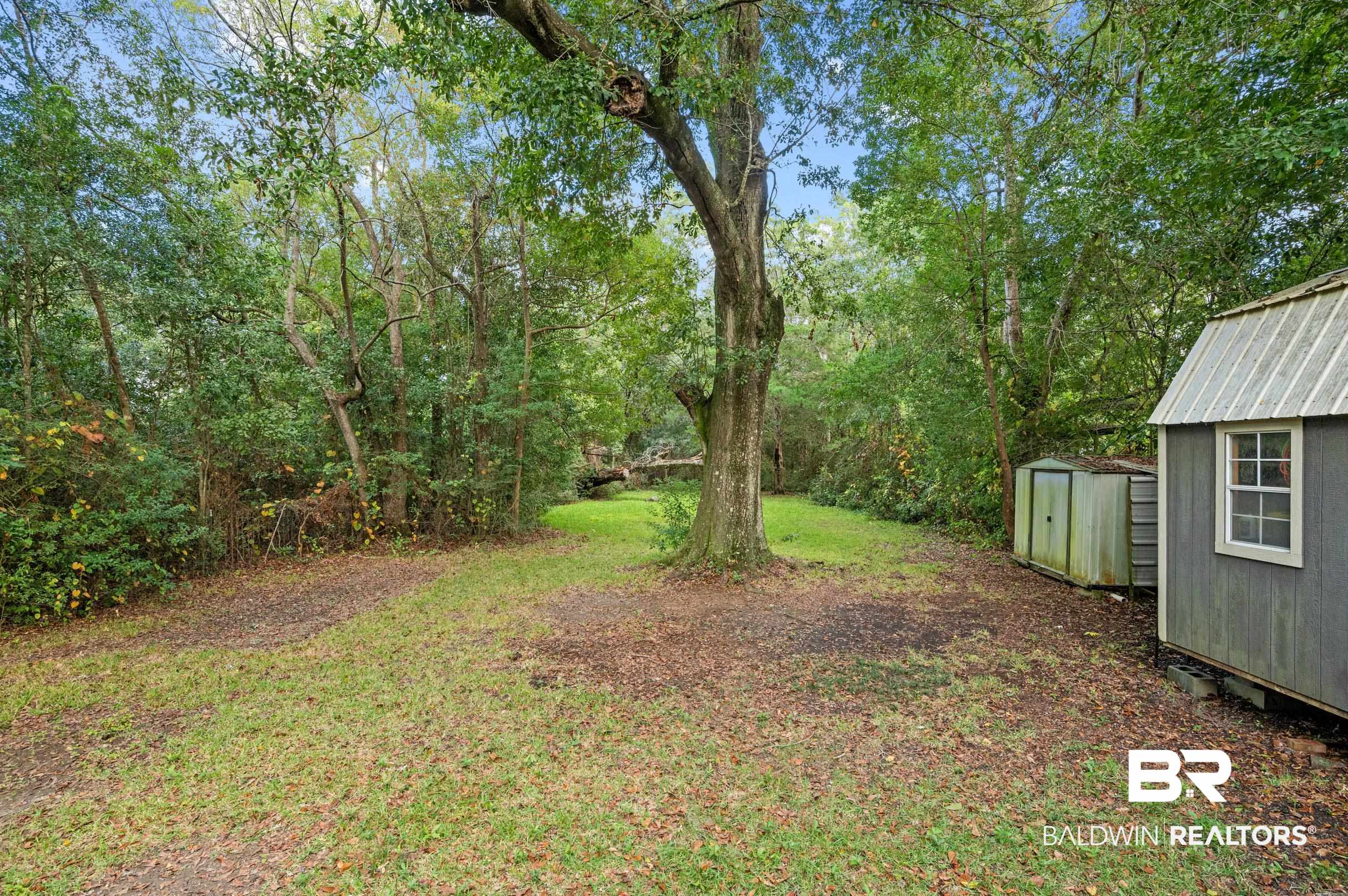 906 North Cedar Street Foley, AL 36535 - Photo 23 of 24 View of yard with a storage shed