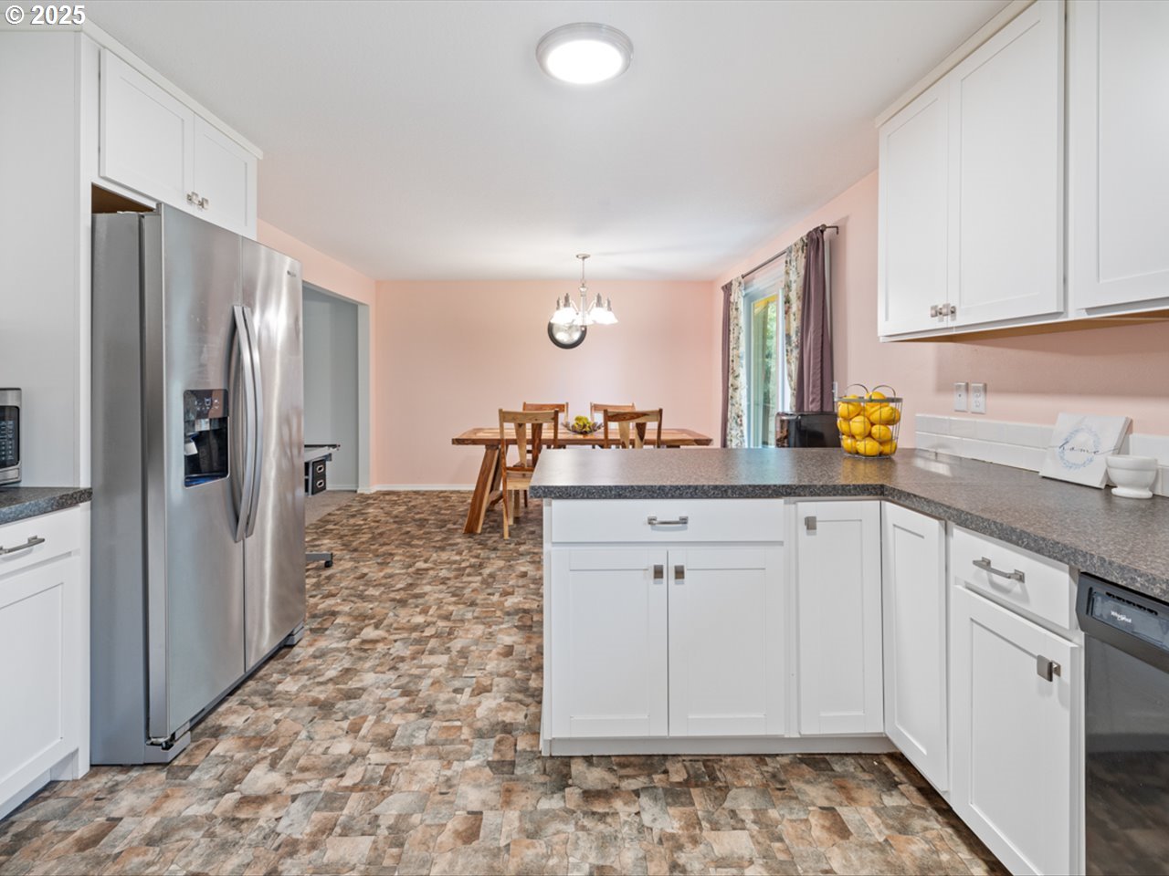 38115 Scravel Hill Road Northeast Albany, OR 97322 - Photo 11 of 46 a kitchen with a sink refrigerator and cabinets