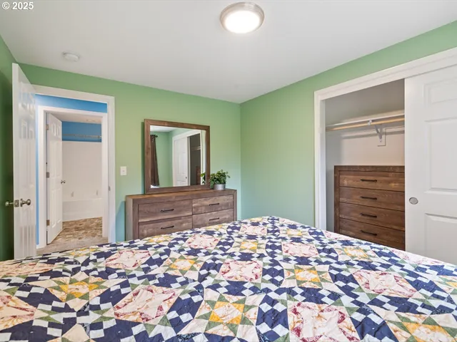 a bedroom with a bed and a dresser