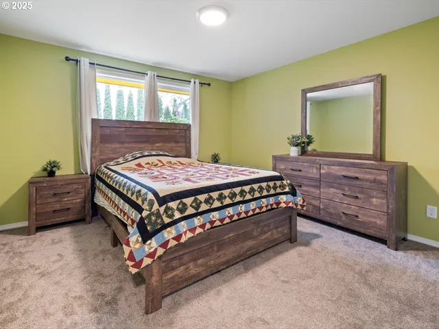 a bedroom with a bed and a dresser