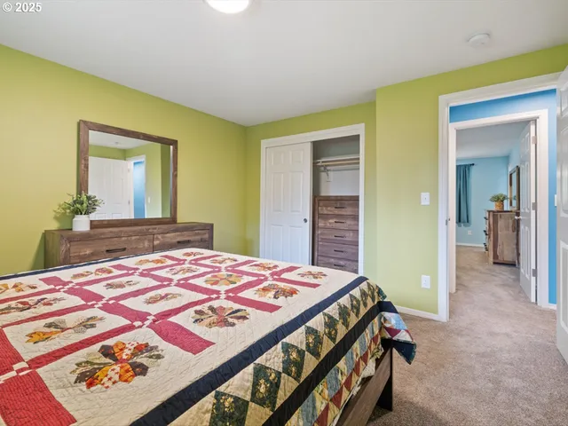 a bedroom with a bed and a dresser