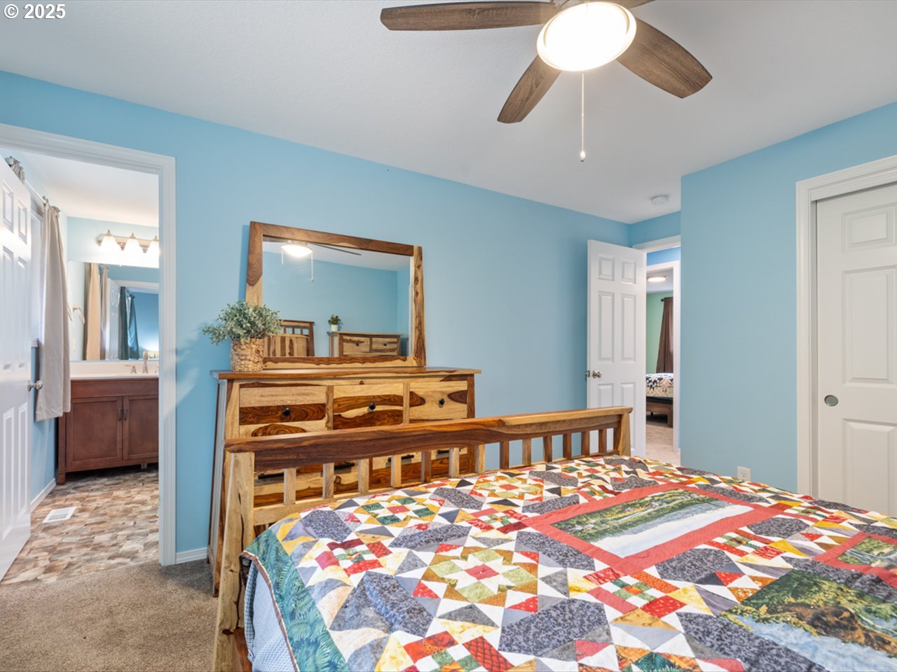 38115 Scravel Hill Road Northeast Albany, OR 97322 - Photo 19 of 46 a bedroom with a bed and a chandelier