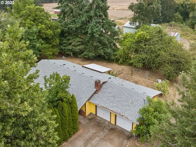 an aerial view of a house with a yard and lake view