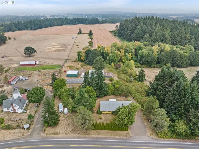 an aerial view of a house with yard