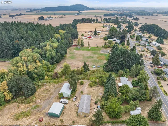an aerial view of a house with outdoor space lake view and mountain view