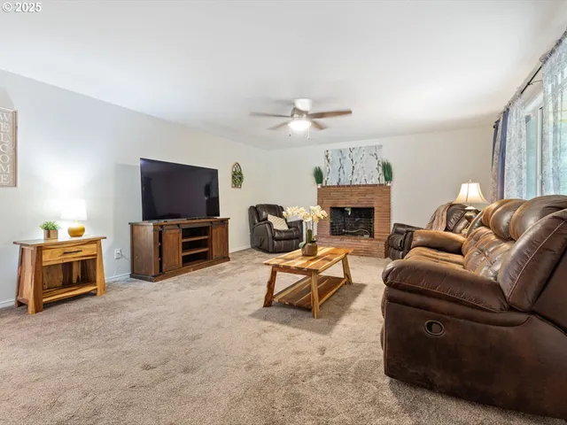 a living room with furniture a fireplace and a flat screen tv