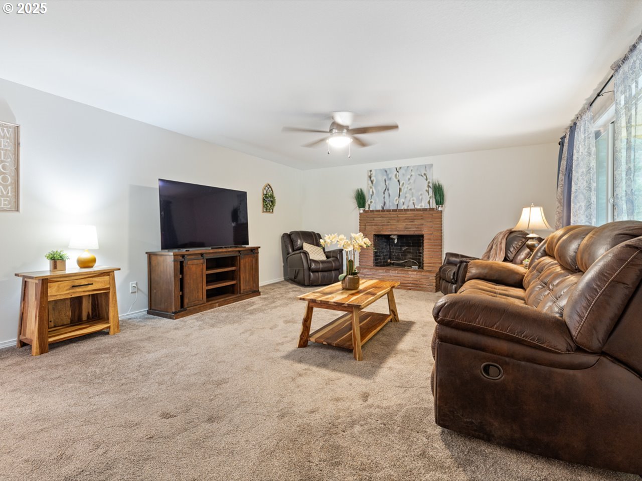 38115 Scravel Hill Road Northeast Albany, OR 97322 - Photo 4 of 46 a living room with furniture a fireplace and a flat screen tv