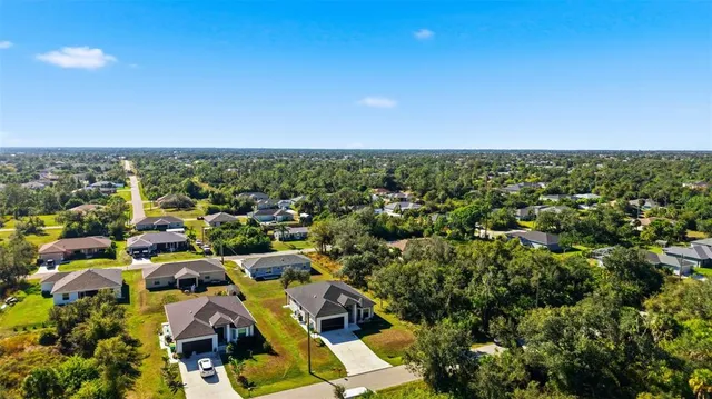 an aerial view of residential house with pool and yard